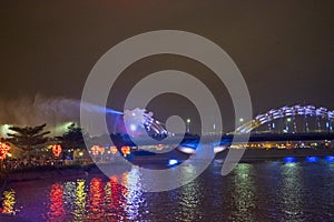 Dragon bridge in Da Nang, Vietnam, at night. The dragon blowing hot fire out of its mouth. A famous attraction in Da Nang