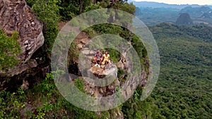 Dragon Crest mountain Krabi Thailand, a Young traveler sits on a rock that overhangs the abyss