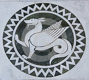 Dragon in a decorative circle on the Chiesa dei Santi Giovanni e Reparata