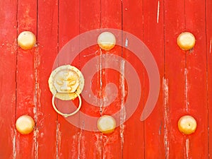 Dragon doorknob on red wooden gate on Mae Salong hill, Chiang ra