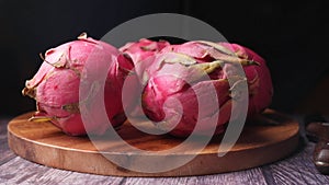 dragon fruit on a chopping board isolated on black