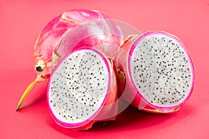 Dragon fruit, Pitahaya, Pitaya exotic asian vegan juicy fruits close up. Over pink background