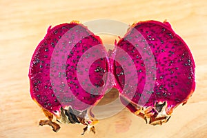 Dragon fruit Pitaya with half on wooden background clipping part