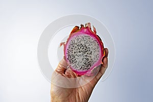 Dragon fruit, Pitaya or Pitahaya on hand in a bright background