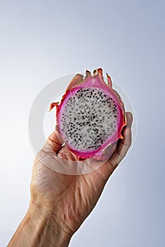 Dragon fruit, Pitaya or Pitahaya on hand in a bright background