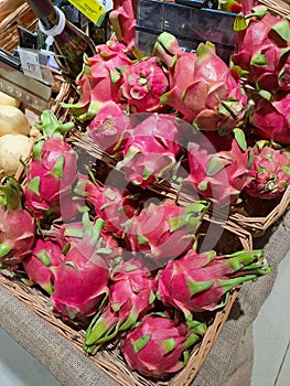 Dragon fruit pitaya pitahaya in wicker baskets in a supermarket