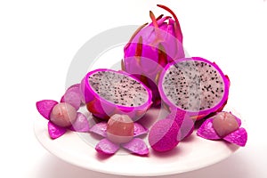 Dragon fruit and two half with open litchi on dish