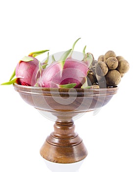 Dragon fruite and Bunch of ripe Langsat on wooden tray