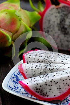 Dragon fruits cut in sliced, tropical Vietnamese fruit, pink peel, white flesh, small seeds