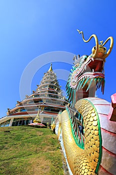 Dragon sculpture and the pagoda at Wat Huay Pla Kang