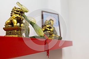 Dragon statue, Buddha statue and lucky charm on a shelf