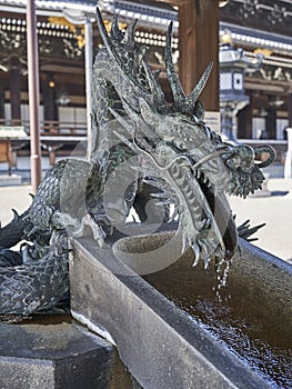 A dragon supplying water at purification fountain. photo