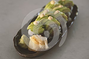 Dragon sushi roll covered with avocado pieces