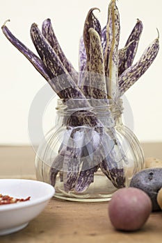 Dragon Tongue Beans bunched in a jar with small mini potatoes an