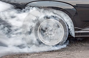 Dragster Car Burn Out Rear Tyre With Smoke photo