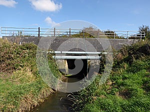 Drain culvet running below railway bridge