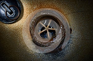 Drain hole with plug in old sink.Close up