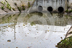 A drain pipe or sewage or sewage discharges waste water into a river. Wastewater or domestic wastewater or municipal wastewater photo