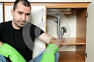 Drain Problems, blockage plumbing kitchen sink pipe unclog male man sit tired