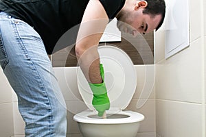 Drain Problems, blockage plumbing toilet unclog plunger force cup man sit floor