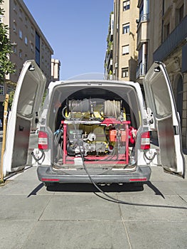 Drain service van at work with open rear doors