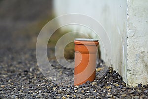 Drainage pipe in the recess of the gutter. Pipe for the water sticking from the ground.
