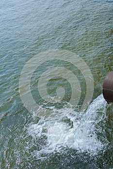 Drainage pipe with water flowing into the river