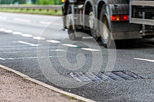 Drainage water collector system on uk motorway with truck in fast motion on background