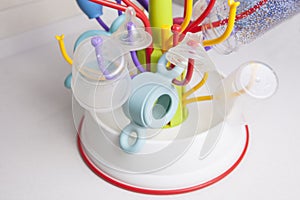 Drainer full of baby plastic tableware objects