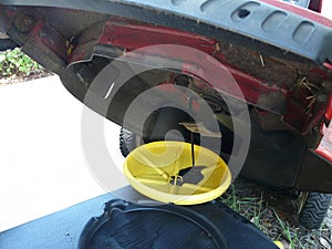 Draining Lawn Mower Oil for Change photo