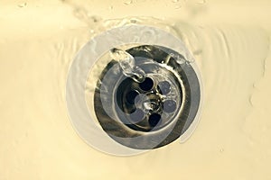 Draining the water into the sink. A drop of water in the sink