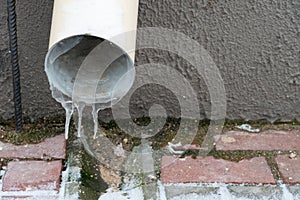The drainpipes are covered with ice and snow. After a heavy snowstorm, the city is covered with snow and ice. There are many