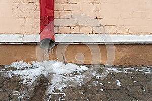 The drainpipes are covered with ice and snow. After a heavy snowstorm, the city is covered with snow and ice. There are many