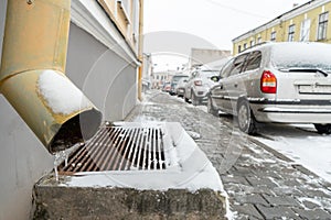 The drainpipes are covered with ice and snow. After a heavy snowstorm, the city is covered with snow and ice. There are many