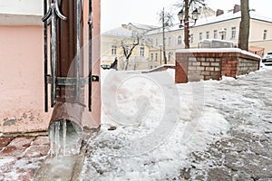 The drainpipes are covered with ice and snow. After a heavy snowstorm, the city is covered with snow and ice. There are many