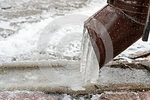 The drainpipes are covered with ice and snow. After a heavy snowstorm, the city is covered with snow and ice. There are many