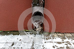 The drainpipes are covered with ice and snow. After a heavy snowstorm, the city is covered with snow and ice. There are many