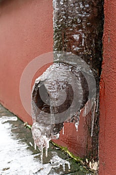 The drainpipes are covered with ice and snow. After a heavy snowstorm, the city is covered with snow and ice. There are many