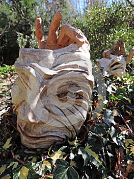 Drama Face and hands sculpture in garden