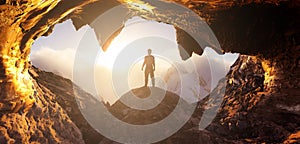 Dramatic Adventurous Scene with Man standing inside a Cave photo