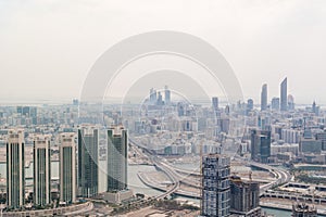 Dramatic aerial shot of a modern city - Abu Dhabi skyline and skyscrapers and Al Reem island - UAE capital city