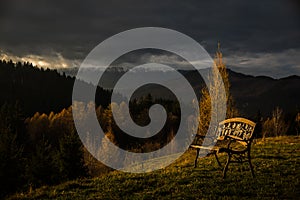 Dramatic autumn Landscape from Transylvania Bran village, Bran, Brasov, Transylvania, Romania with a bench in the middle of the