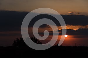 Dramatic and beautiful sunset, cloudy sky with parts of intense orange color