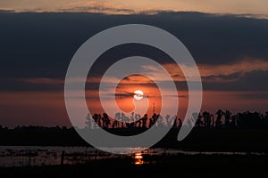 Dramatic and beautiful sunset, cloudy sky with parts of intense orange color