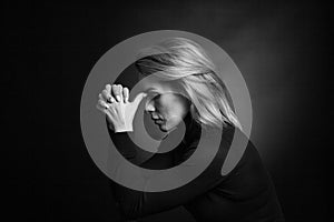 Dramatic black and white portrait of a beautiful woman on a dark background