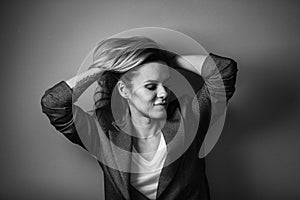 Dramatic black and white portrait of a beautiful woman on a dark background