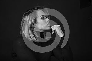 Dramatic black and white portrait of a beautiful woman on a dark background