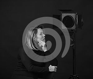 Dramatic black and white portrait of a beautiful woman on a dark background