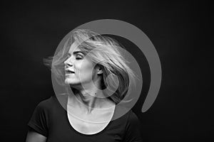 Dramatic black and white portrait of a beautiful woman on a dark background