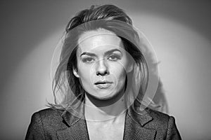 Dramatic black and white portrait of a beautiful woman on a dark background